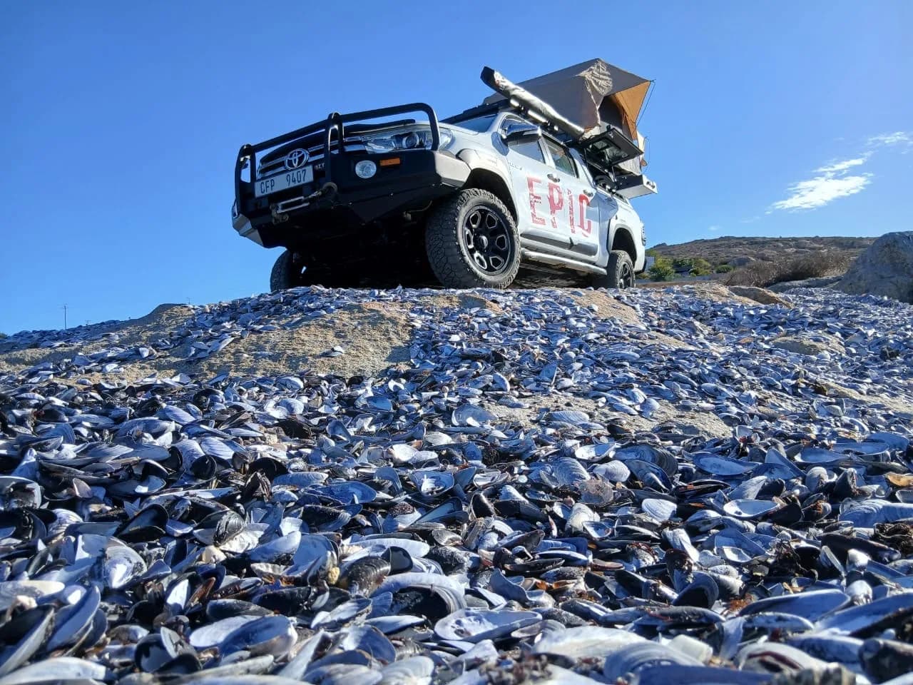 A fully expedition-rigged Toyota Hilux, three-quarter view